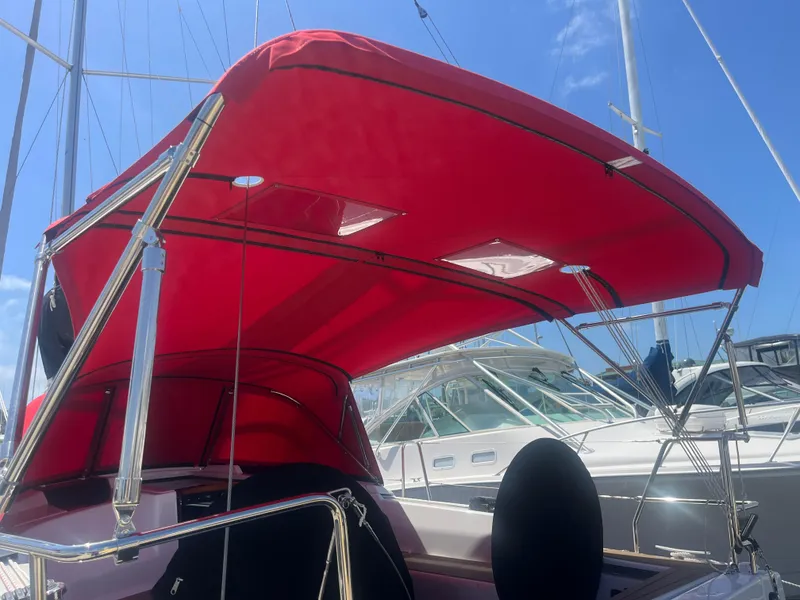 Slide: The Image of Red canopy on a 2026 Hanse 348 sailboat under a clear blue sky. - 34