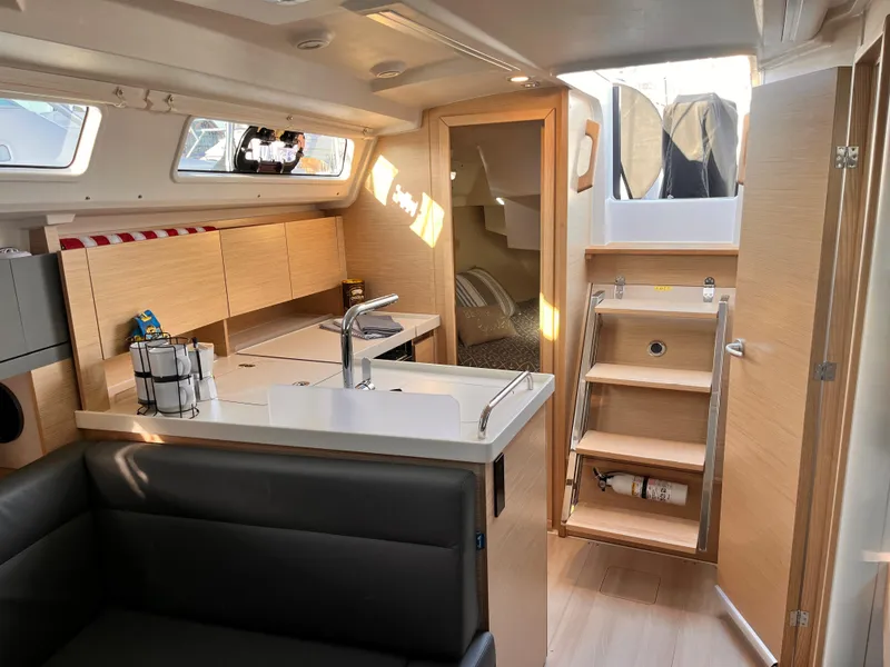 Slide: The Image of Modern interior of 2026 Hanse 348 sailboat with sleek kitchen and cozy seating area. - 4