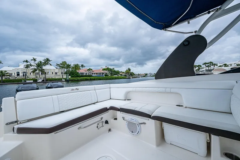 Slide: The Image of 2018 Sea Ray SDX 290 Outboard boat interior with luxurious seating and waterfront view. - 21