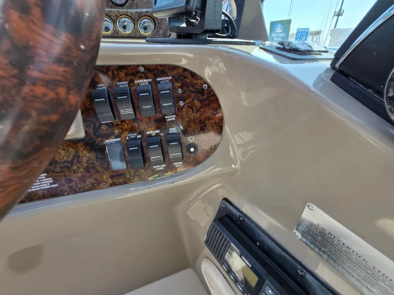 Slide: The Image of 2003 Four Winns 328 Vista dashboard with control switches and gauges. - 20