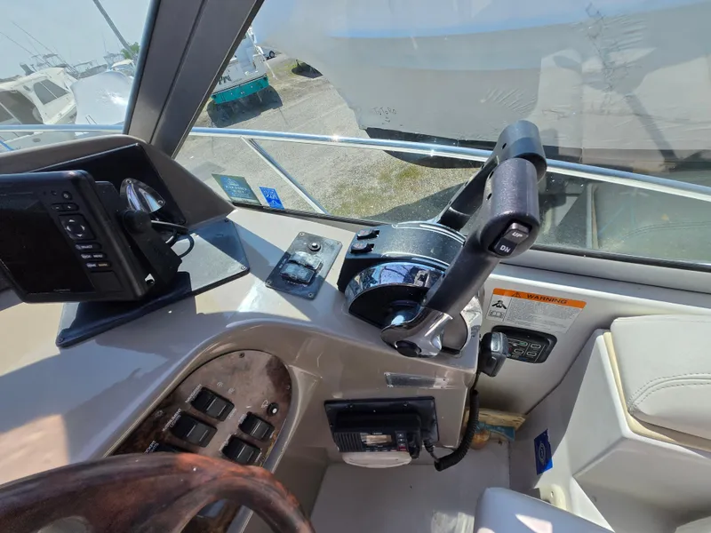 Slide: The Image of Helm of 2003 Four Winns 328 Vista boat with steering controls and navigation equipment. - 21