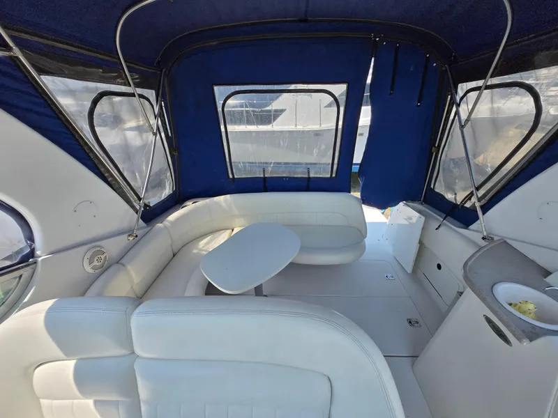 Slide: The Image of 2003 Four Winns 328 Vista boat interior with blue canopy and white seating. - 22
