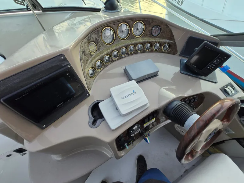 Slide: The Image of 2003 Four Winns 328 Vista boat dashboard with Garmin navigation system and multiple gauges. - 25