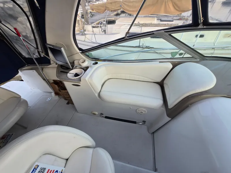 Slide: The Image of 2003 Four Winns 328 Vista boat interior with white seating and control panel. - 26