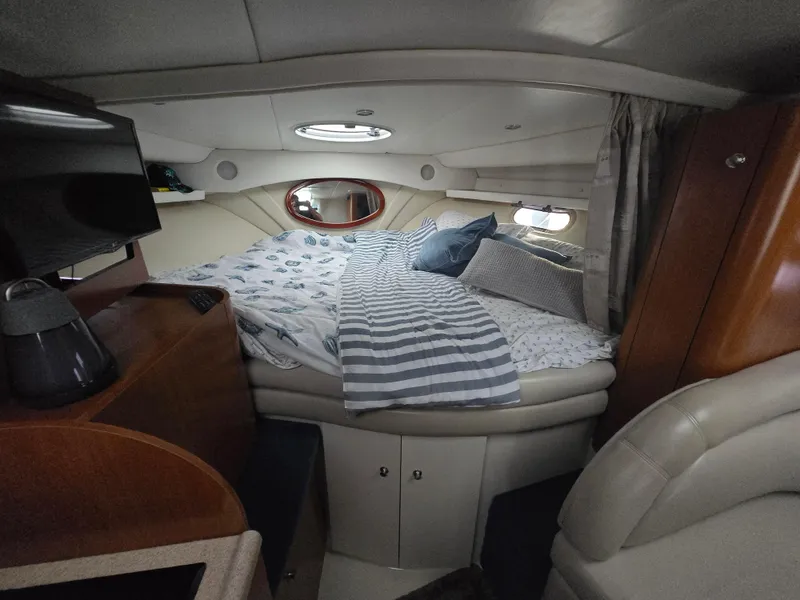 Slide: The Image of Cozy cabin interior of 2003 Four Winns 328 Vista with bed and porthole window. - 28