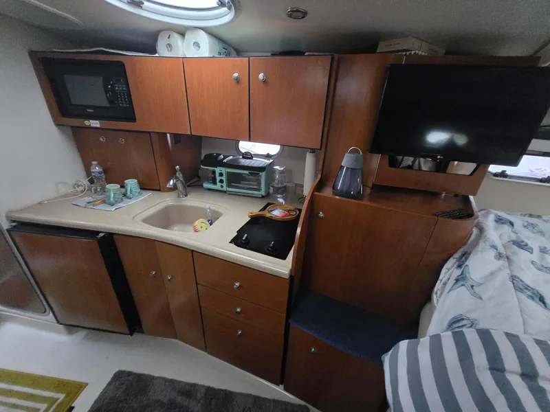 Slide: The Image of Interior of a 2003 Four Winns 328 Vista boat with kitchenette and TV. - 29