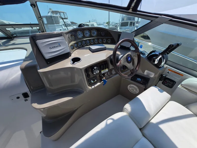 Slide: The Image of 2003 Four Winns 328 Vista boat cockpit with Garmin navigation and modern controls. - 35