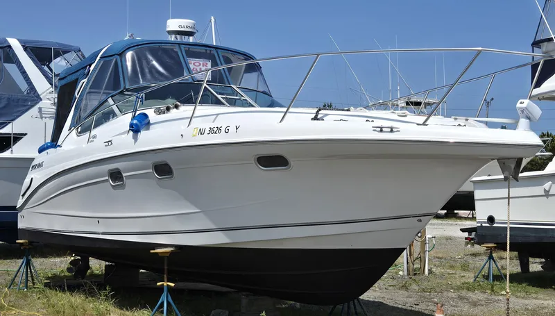 Slide: The Image of 2003 Four Winns 328 Vista boat on stands, displayed outdoors. - 39