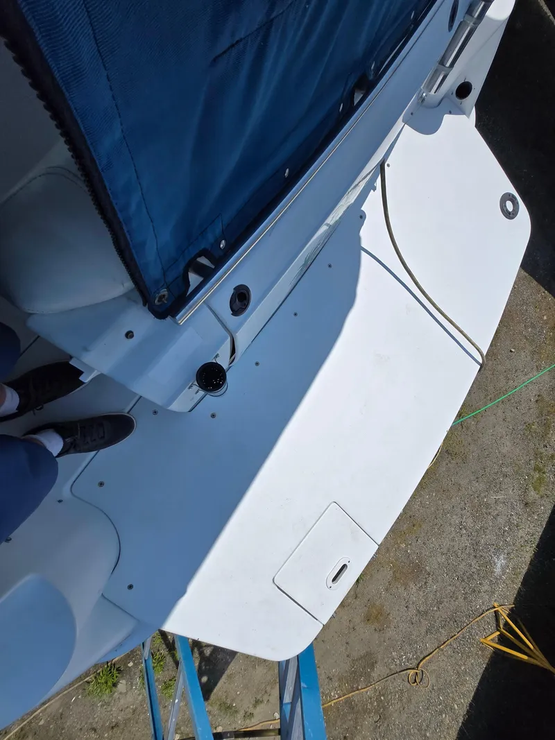 Slide: The Image of 2003 Four Winns 328 Vista boat deck with blue cover and visible dock lines. - 40