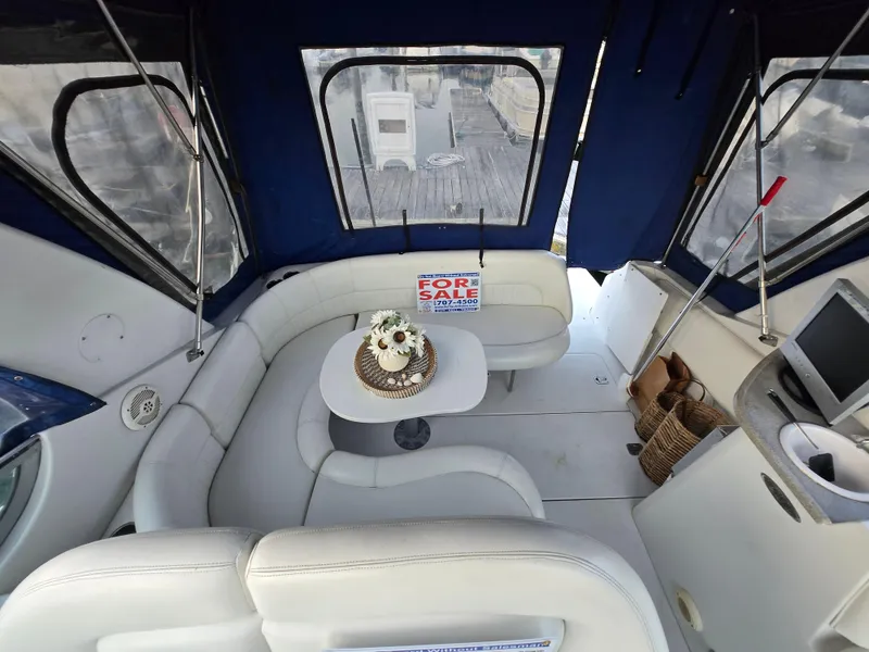 Slide: The Image of 2003 Four Winns 328 Vista boat interior with seating, table, and "For Sale" sign. - 6