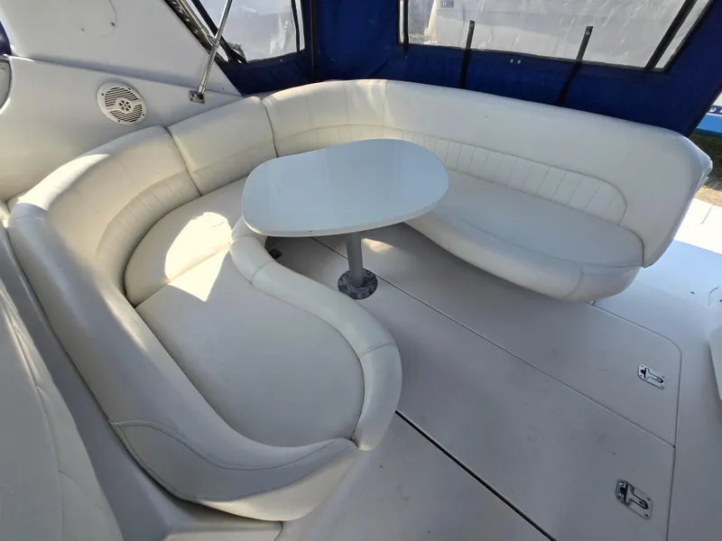 Slide: The Image of 2003 Four Winns 328 Vista boat interior with white seating and table. - 7