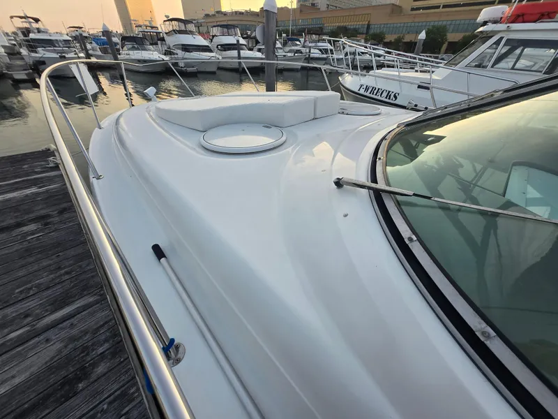 Slide: The Image of 2003 Four Winns 328 Vista boat docked at marina, surrounded by other vessels. - 9