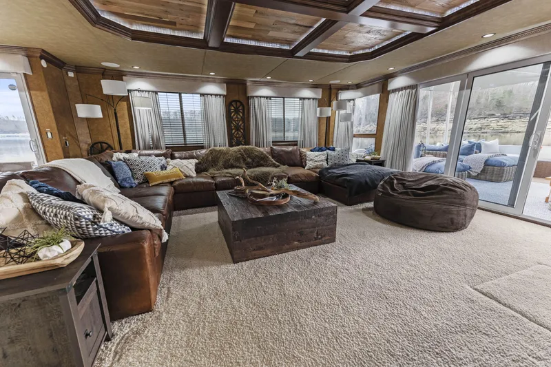 Slide: The Image of Spacious living room with cozy seating, large windows, and rustic decor. - 11