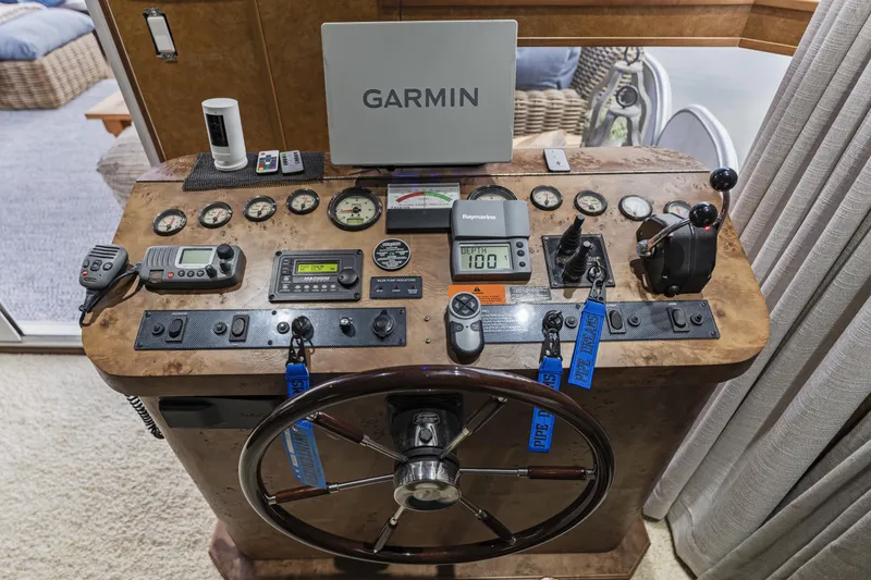 Slide: The Image of Boat helm with Garmin navigation, Sharpe 20 x 100, 2009 model, featuring various controls and gauges. - 12