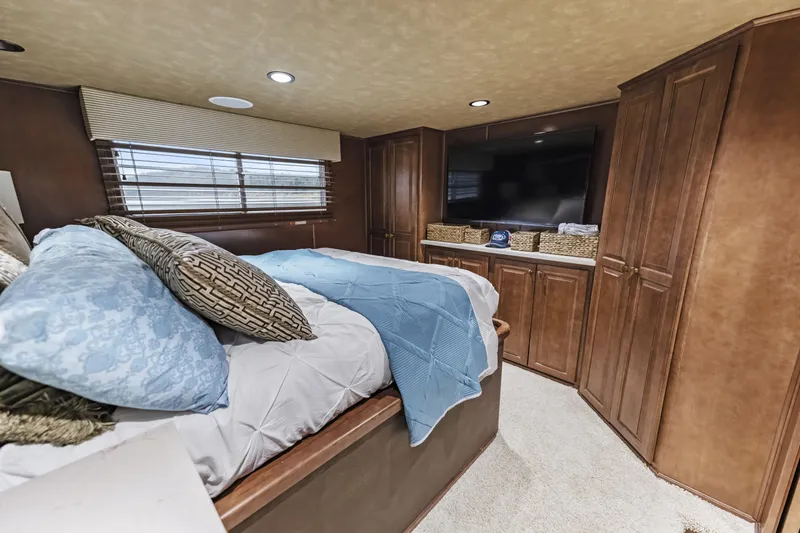 Slide: The Image of Luxurious bedroom interior in 2009 Sharpe 20 x 100 houseboat with cozy bedding and wooden cabinetry. - 17