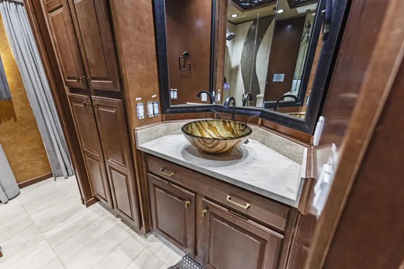 Slide: The Image of Luxurious bathroom with wooden cabinets, vessel sink, and elegant decor in a Sharpe 20 x 100, 2009. - 19