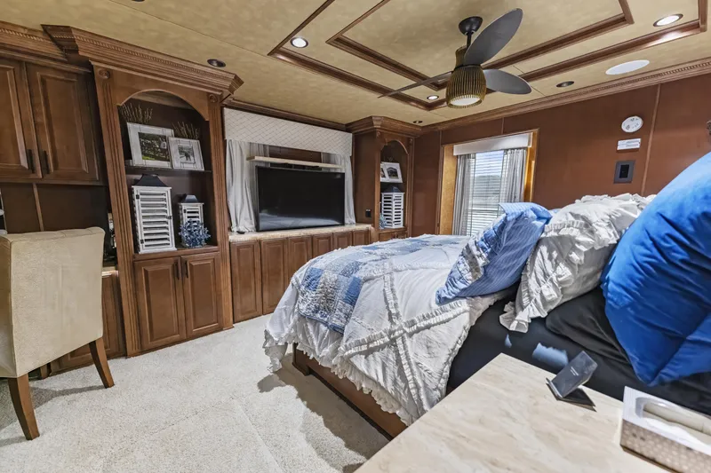 Slide: The Image of Luxurious bedroom interior in 2009 Sharpe 20 x 100 houseboat with wood cabinetry and cozy bedding. - 23