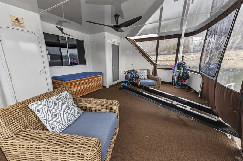 Slide: The Image of Houseboat interior with wicker furniture, ceiling fan, and water sports equipment, Sharpe 20 x 100, 2009. - 27