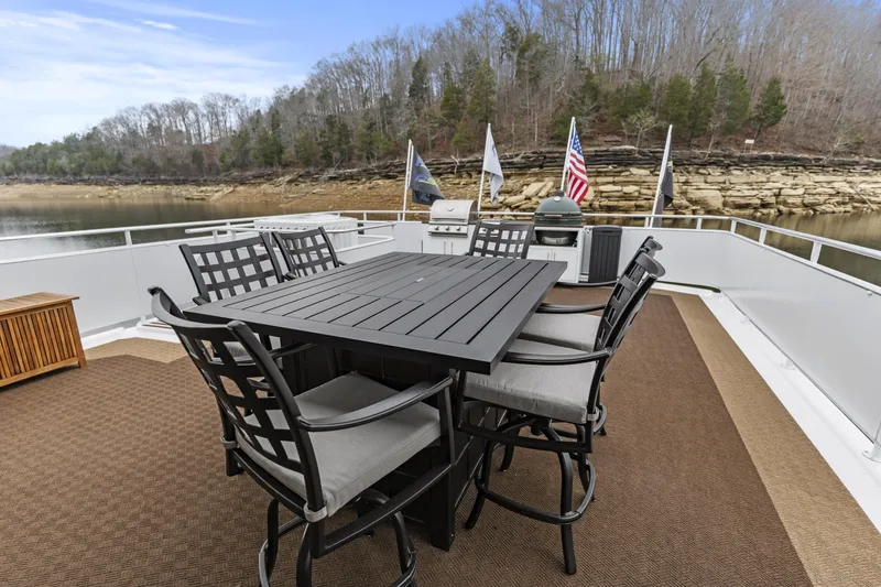 Slide: The Image of Outdoor dining set on a Sharpe 20 x 100 houseboat deck, 2009 model, with scenic lake view. - 30