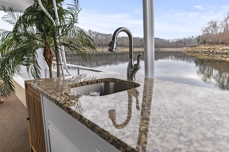 Slide: The Image of Granite countertop with sink on a 2009 Sharpe 20 x 100 houseboat, overlooking a serene lake. - 37