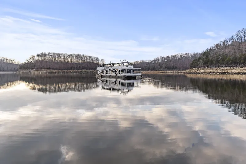 Slide: The Image of Houseboat on calm lake with cloudy sky reflection, surrounded by trees; Sharpe 20 x 100, 2009 model. - 49