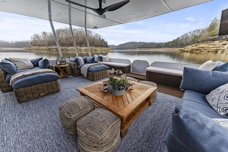 Slide: The Image of Luxurious houseboat interior with wicker furniture, lake view, and cozy seating. Sharpe 20 x 100, 2009. - 5