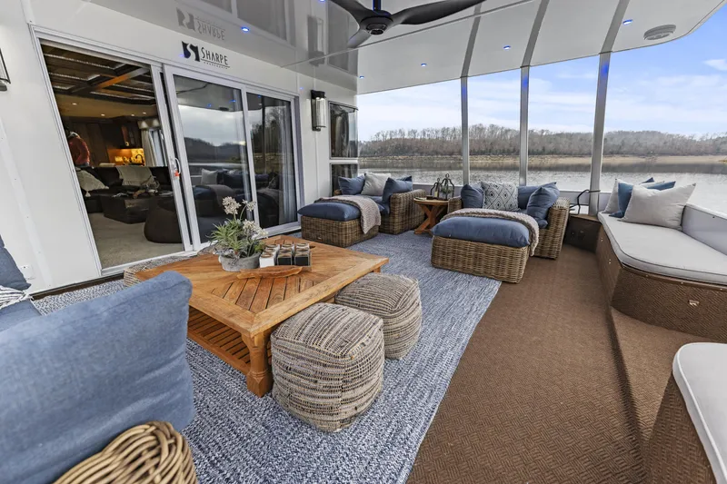 Slide: The Image of Luxurious 2009 Sharpe houseboat interior with cozy seating and scenic river views. - 7