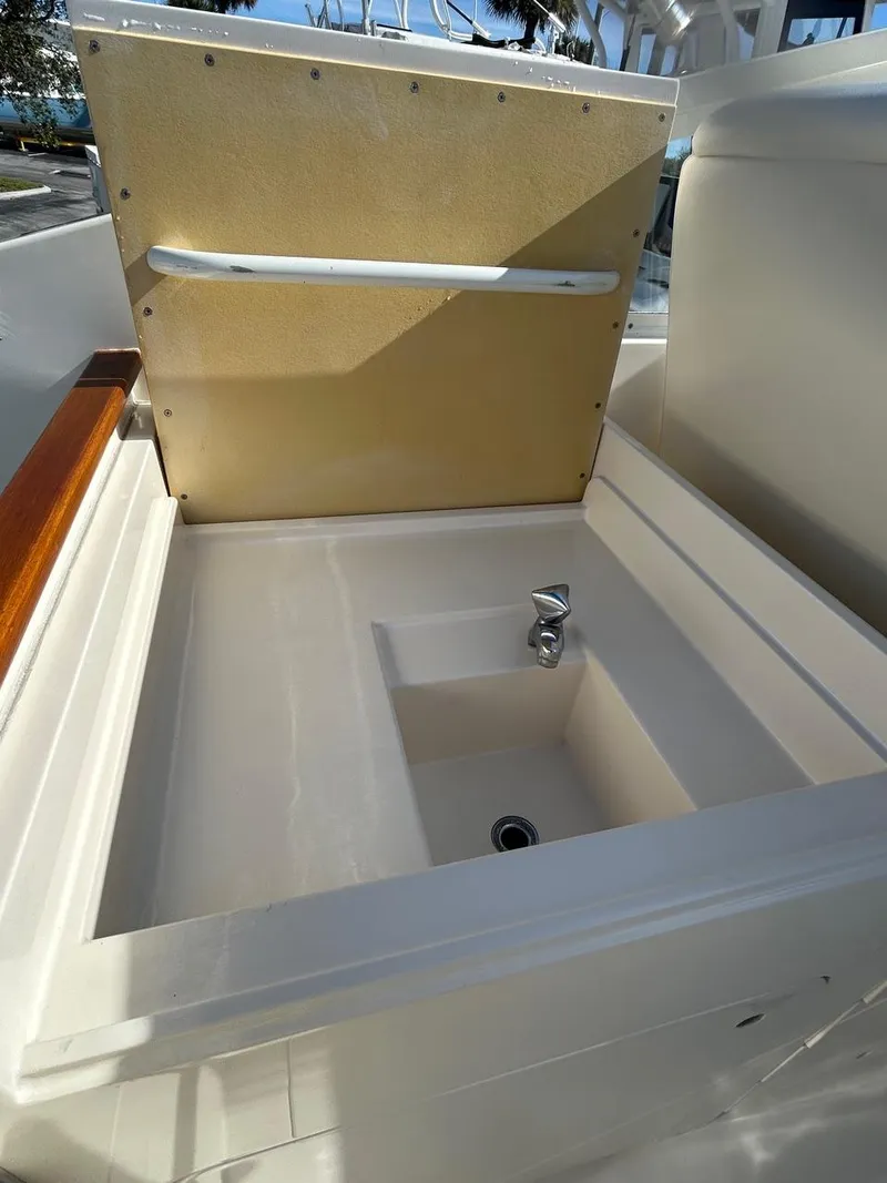 Slide: The Image of 1988 Bertram 28 Moppie boat sink with open lid and faucet. - 10