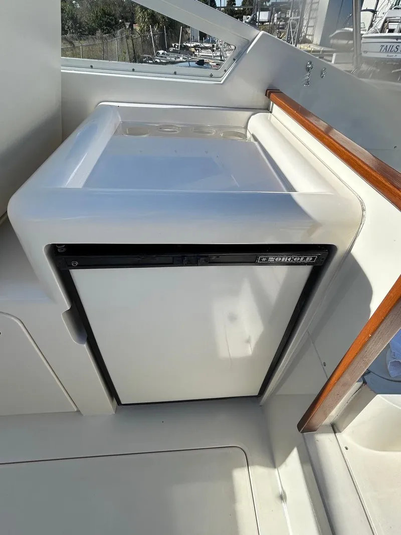 Slide: The Image of 1988 Bertram 28 Moppie boat interior with compact refrigerator. - 11