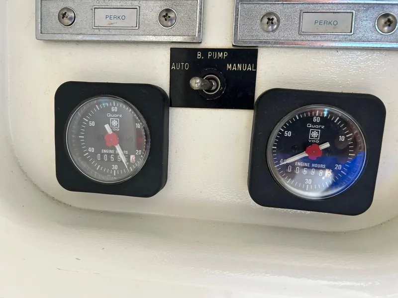 Slide: The Image of Dashboard gauges and switches on a 1988 Bertram 28 Moppie boat. - 14