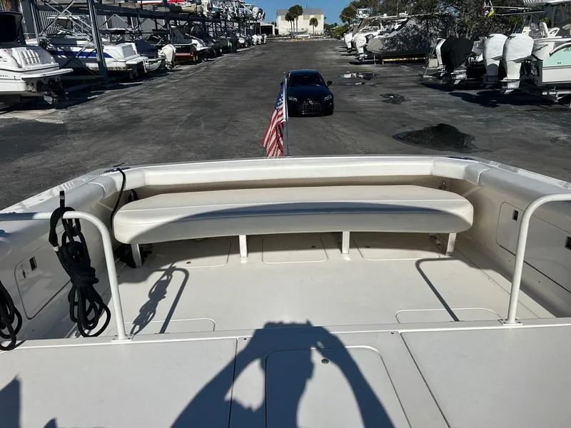Slide: The Image of 1988 Bertram 28 Moppie boat with spacious seating, docked in a marina. - 15
