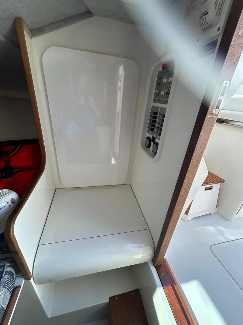 Slide: The Image of 1988 Bertram 28 Moppie cabin interior with control panel and seating area. - 19