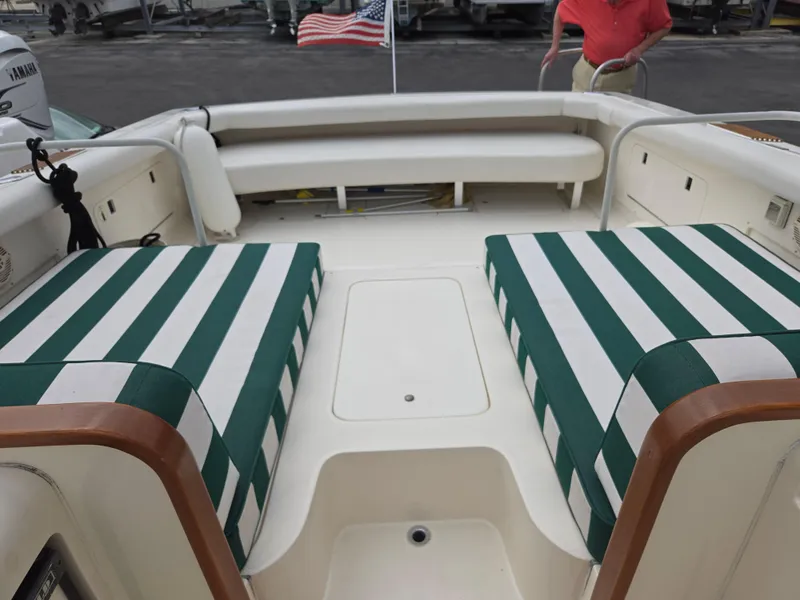 Slide: The Image of 1988 Bertram 28 Moppie boat interior with striped seating and American flag. - 20
