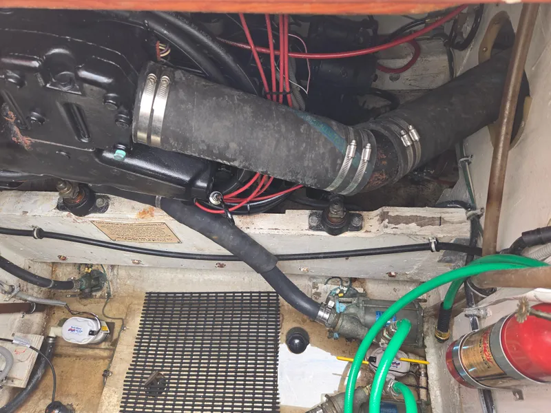 Slide: The Image of Engine compartment of a 1988 Bertram 28 Moppie boat, showing hoses and wiring. - 33