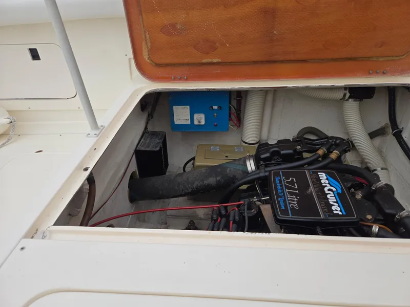 Slide: The Image of Engine compartment of a 1988 Bertram 28 Moppie boat, featuring a 5.7-liter MerCruiser engine. - 37