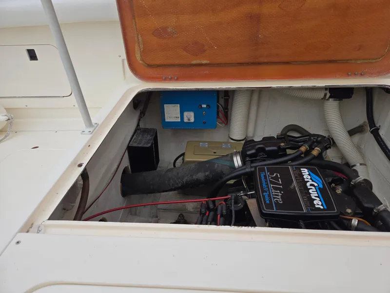 Slide: The Image of Engine compartment of a 1988 Bertram 28 Moppie boat, featuring a MerCruiser 5.7L engine. - 38