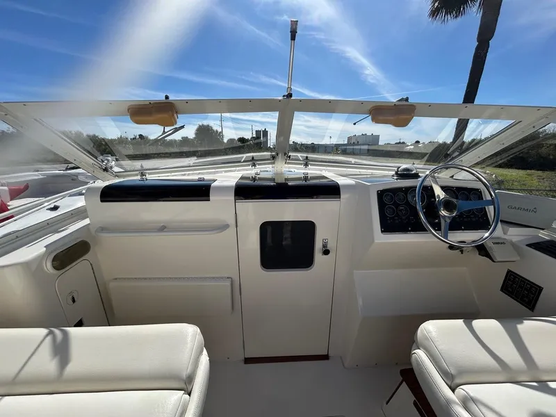 Slide: The Image of Interior view of 1988 Bertram 28 Moppie boat cockpit with steering wheel and dashboard. - 7