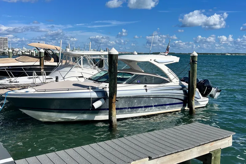 Slide: The Image of 2023 Formula 330 CBR boat docked at marina under blue sky. - 1