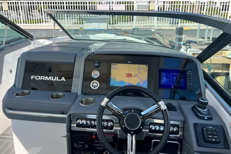 Slide: The Image of 2023 Formula 330 CBR boat dashboard with navigation screens and controls. - 11