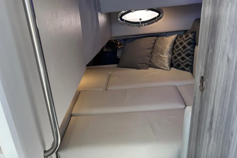 Slide: The Image of 2023 Formula 330 CBR cabin interior with cozy bedding and decorative pillows. - 17