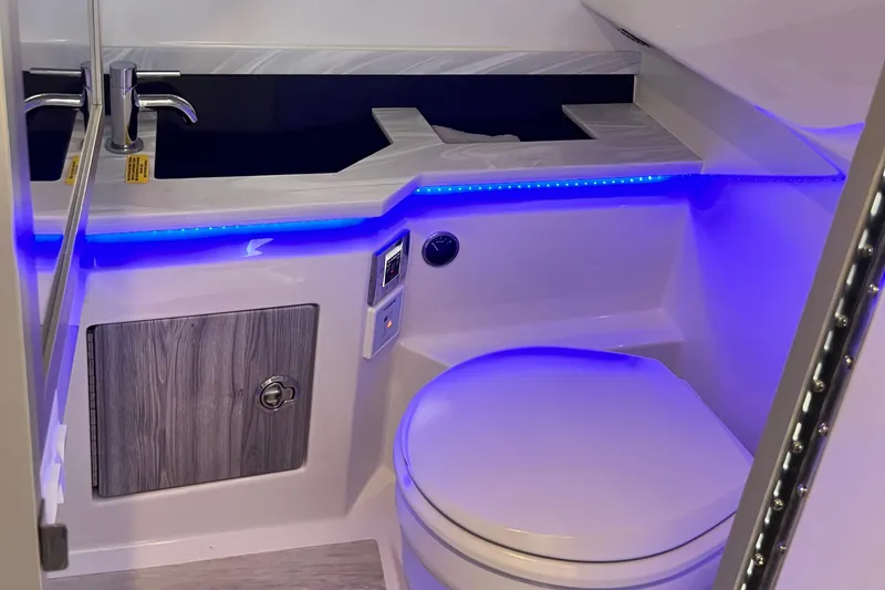 Slide: The Image of 2023 Formula 330 CBR boat bathroom with modern design and blue LED lighting. - 18