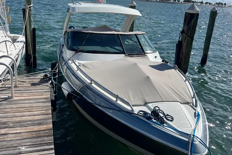 Slide: The Image of 2023 Formula 330 CBR boat docked on a sunny day. - 2