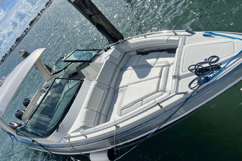 Slide: The Image of 2023 Formula 330 CBR boat with spacious seating, docked on a sunny day. - 4