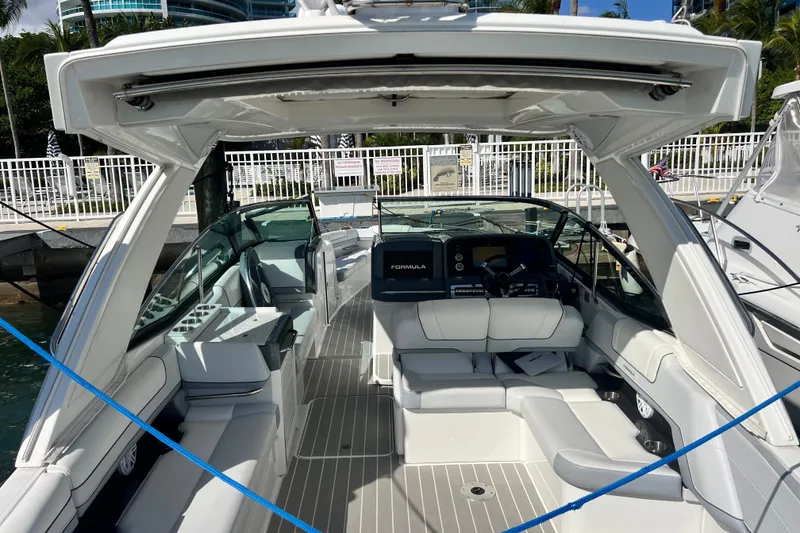 Slide: The Image of 2023 Formula 330 CBR luxury boat interior with sleek seating and modern dashboard. - 6