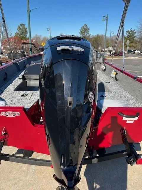 Slide: The Image of 2025 Tracker Pro Guide V-16 SC boat with powerful outboard motor, red and gray design. - 2