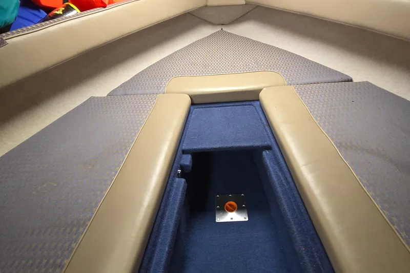 Slide: The Image of Interior view of a 2001 Bayliner 23 Capri boat with cushioned seating. - 3