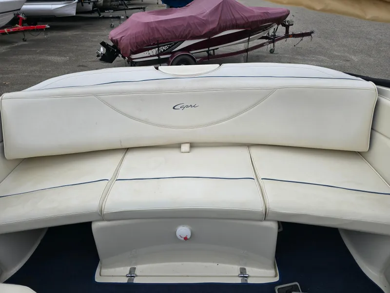 Slide: The Image of 2001 Bayliner 23 Capri boat interior with white cushioned seating. - 6