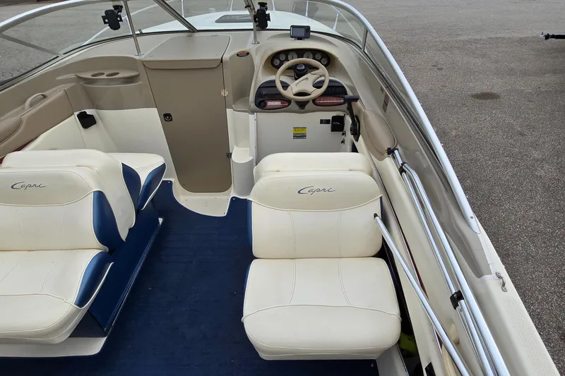 Slide: The Image of 2001 Bayliner 23 Capri boat interior with white seating and blue carpet. - 7