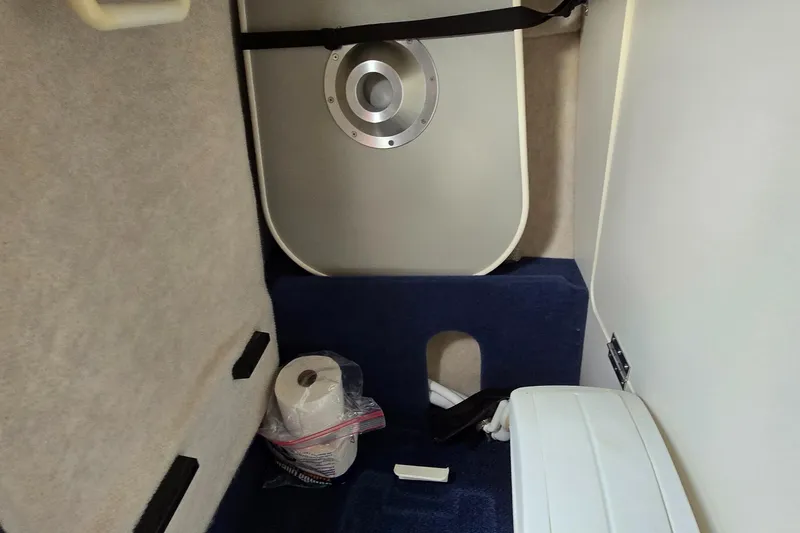 Slide: The Image of Interior of a 2001 Bayliner 23 Capri boat cabin with toilet paper and storage. - 8