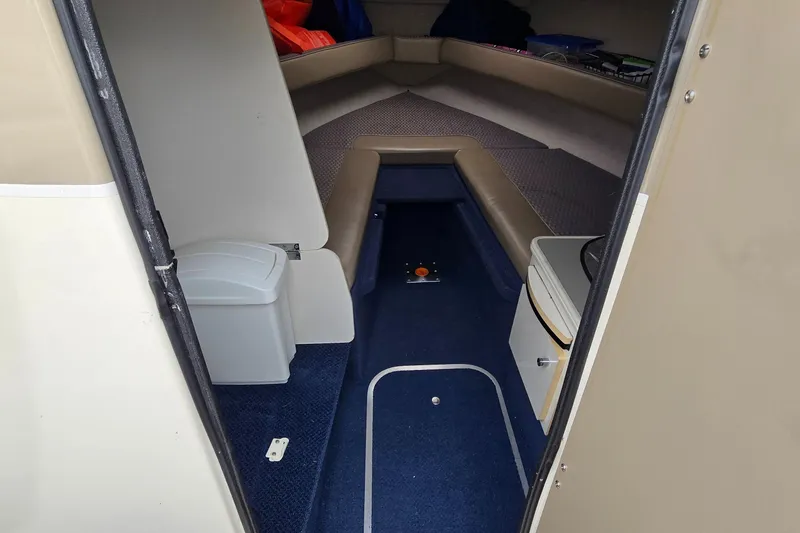 Slide: The Image of 2001 Bayliner 23 Capri cabin interior with seating and storage. - 9